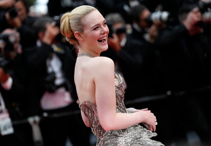 Elle Fanning poses for photographers upon arrival at the opening ceremony. AP