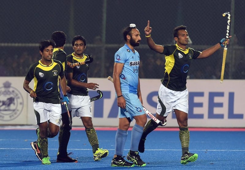 A dejected India hockey captain Sardar Singh, second right, looks on as Pakistan players celebrate their Champions Trophy semi-final victory after they did not win a single group match. Prakash Singh / AFP

