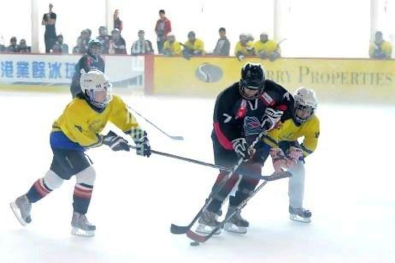 An Abu Dhabi Storms player is challenged by two Bangkok C Girls players during a 1-1 draw in the penultimate match of the Hong Kong Mega Ice Fives tournament in Hong Kong. Courtesy of Abu Dhabi Ice Sports Club