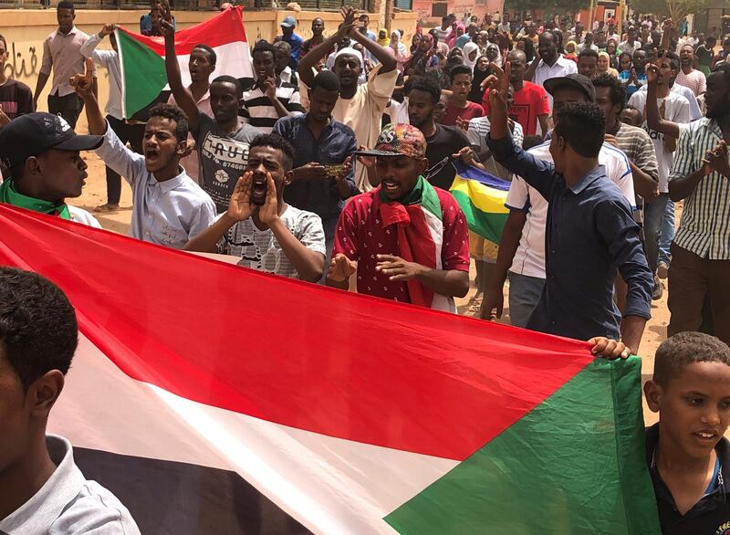 Sudanese protesters hold their national flag and shout slogans during a demonstration against the military council, in Khartoum, Sudan, Sunday, on June 30, 2019. AP Photo