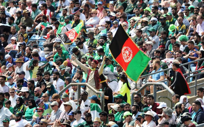 A cricket fan waves the Afghan national flag during the Cricket World Cup match between Pakistan and Afghanistan at Headingley in Leeds, England, Saturday, June 29, 2019. (AP Photo/Rui Vieira)