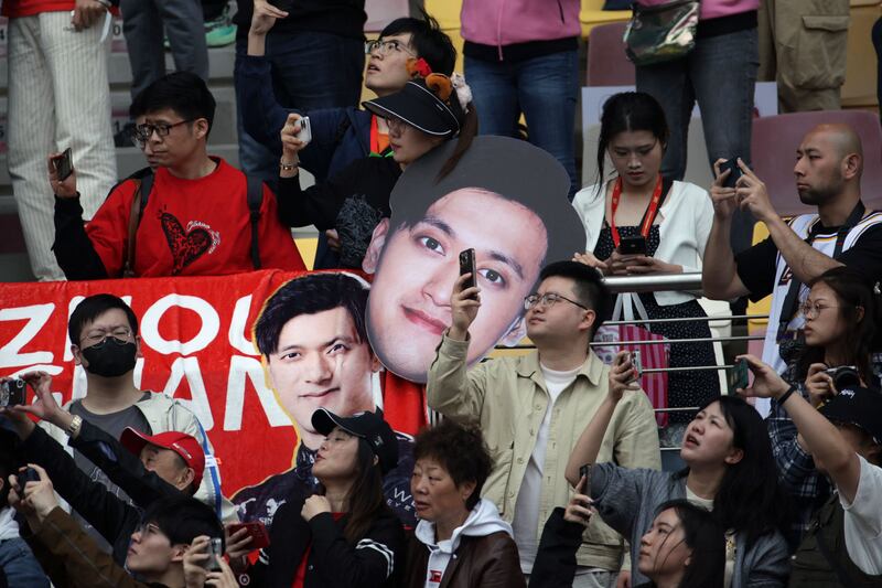 Fans hold banners of Kick Sauber's Chinese driver Zhou Guanyu. AFP