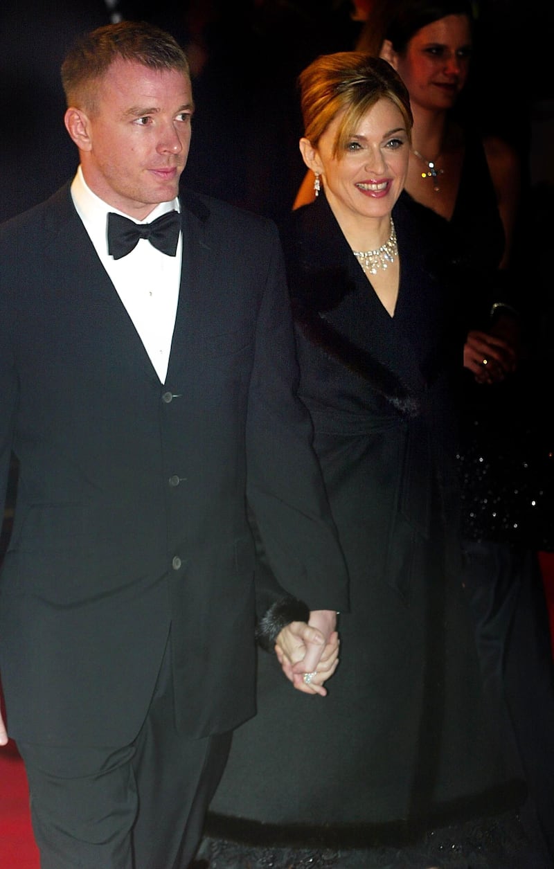 LONDON - NOVEMBER 18:  Singer Madonna (R) and her husband director Guy Ritchie arrive for the world premiere of "Die Another Day" at the Royal Albert Hall in the presence of Britain's Queen and the Duke of Edinburgh November18, 2002 in London. (Photo by Scott Barbour/Getty Images) 