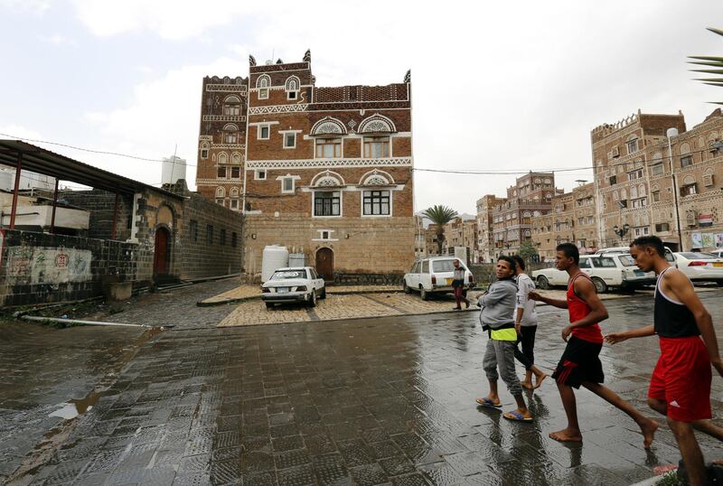 Yemenis walk past historic buildings in the old quarter of Sanaa, Yemen. EPA