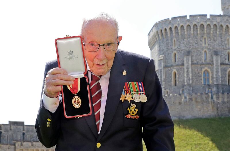 Captain Tom poses with his knighthood. AP Photo