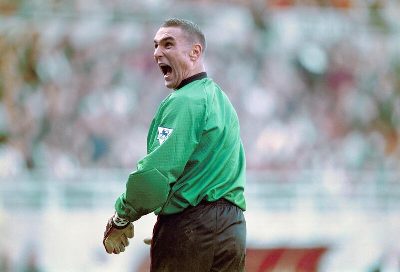 NEWCASTLE UPON TYNE, UNITED KINGDOM - OCTOBER 21: Wimbledon stand in goalkeeper Vinny Jones shares a joke with Newcastle fans in the Gallowgate end after taking over the gloves during the Premier League match at St James' Park which Newcastle won 6-1 on October 21, 1995 in Newcastle Upon Tyne, England.  (Photo by Ross Kinnaird/Allsport/Getty Images)