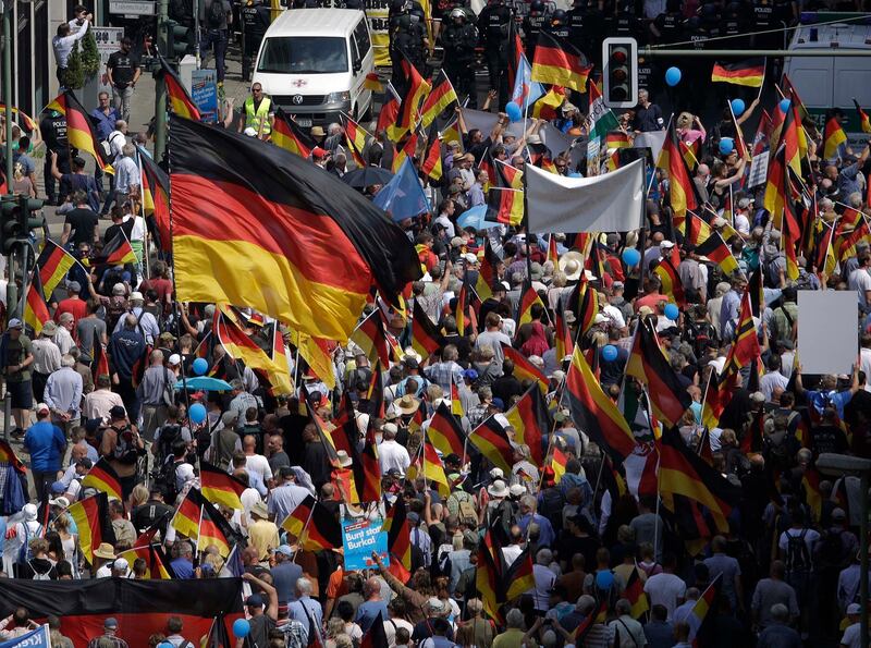 AfD supporters march in Berlin, Germany, Sunday, May 27, 2018. The AfD that swept into Parliament last year on a wave of anti-migrant sentiment is staging a march Sunday through the heart of Berlin to protest against the government. (AP Photo/Markus Schreiber)