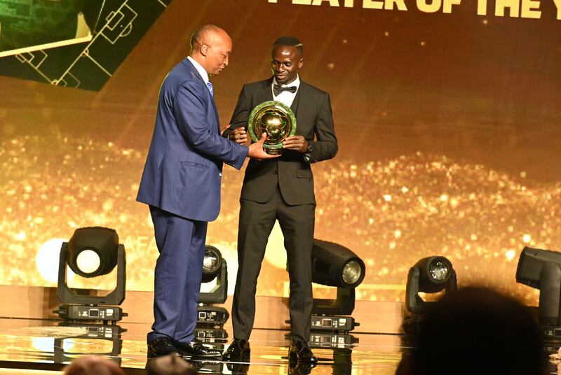 Senegalese forward Sadio Mane receives the Men's Player of the Year from CAF President Patrice Motsepe. EPA