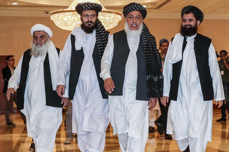 (FILES) In this file photo taken on July 8, 2019, Mohammad Nabi Omari (C-L), a Taliban member formerly held by the US at Guantanamo Bay and reportedly released in 2014 in a prisoner exchange, Taliban negotiator Abbas Stanikzai (C-R), and former Taliban intelligence deputy Mawlawi Abdul Haq Wasiq (R) walk with another Taliban member during the second day of the Intra Afghan Dialogue talks in the Qatari capital Doha. An Afghanistan peace agreement that the US seems close to reaching with the Taliban has prompted worries that President Donald Trump's eagerness to withdraw US troops risks worsening the  civil war and again creating a haven for terrorists. Trump said on August 17, 2019 he was pleased with talks on ending the war, 18 years after the September 11, attacks that prompted the US invasion of Afghanistan in the first place. / AFP / KARIM JAAFAR
