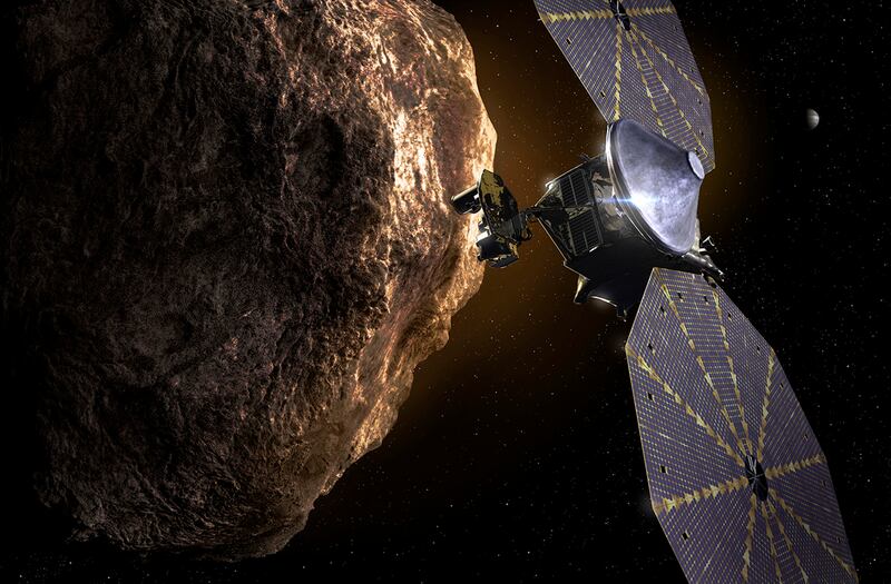 This image provided by the Southwest Research Institute depicts the 'Lucy' spacecraft approaching an asteroid. It will be the first space mission to explore a diverse population of small bodies known as the Jupiter Trojan asteroids.  AP Photo