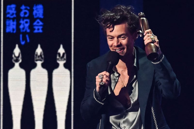 British singer Harry Styles celebrates after receiving the Album of the Year award for Harry's House during the Brit Awards 2023 ceremony and live show in London on February 11, 2023. AFP