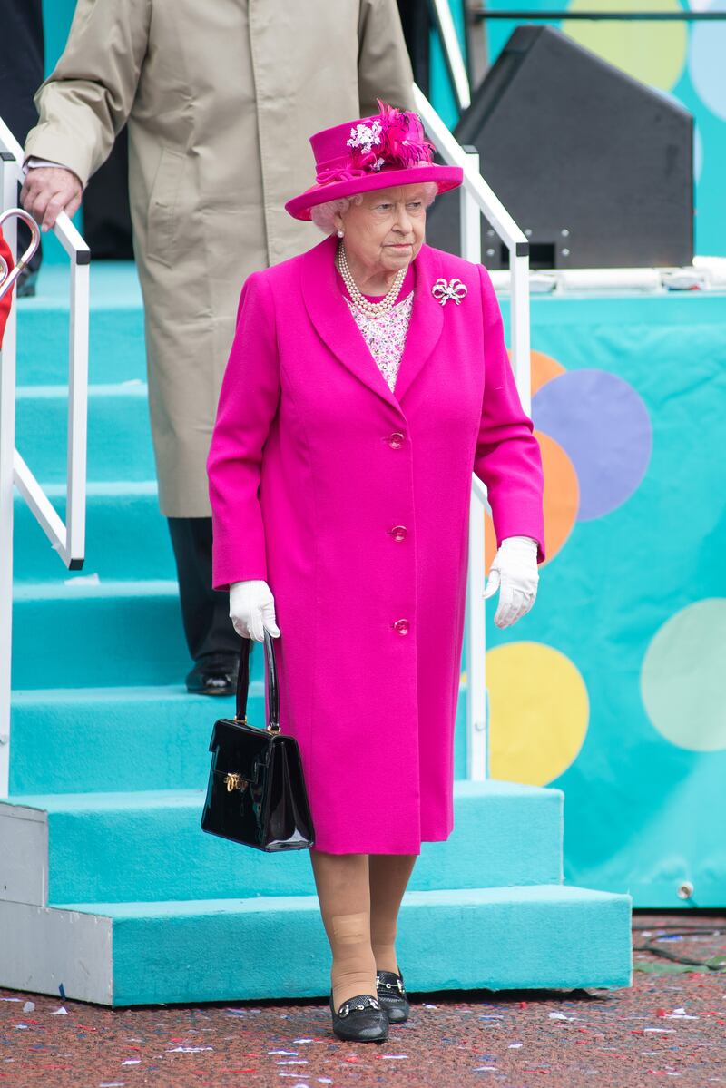 Queen Elizabeth II, wearing pink, during the Patron's Lunch at The Mall, London, for her 90th birthday celebrations on June 12, 2016. Getty Images