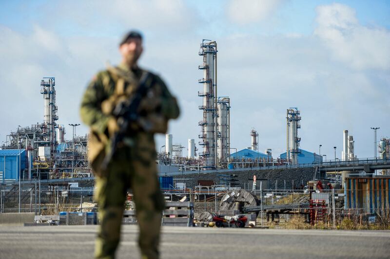 A Norwegian serviceman stands guard at a gas processing plant following the Baltic Sea leaks. AFP