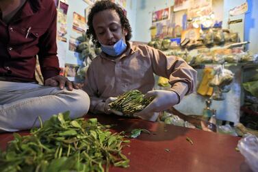 A Yemeni vendor sorts leaves of qat, the ubiquitous mild narcotic, at a market in the capital Sanaa on May 1, 2020. AFP