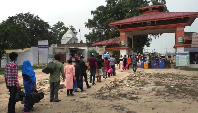 People queue in Nepalgunj, Nepal, to enter India.