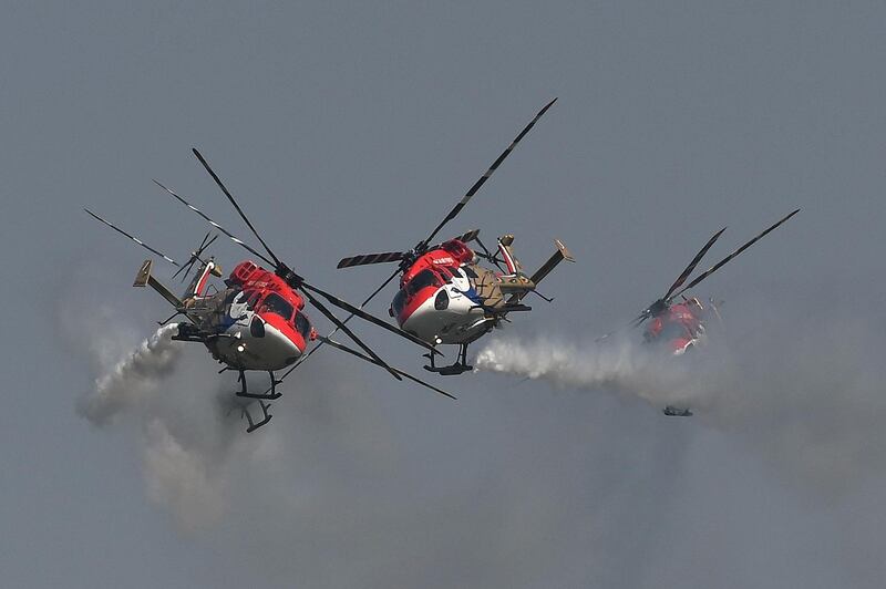 Helicopters of the Indian Air Force's Sarang aerobatics team perform during the Air Force Day parade at an IAF station in Ghaziabad. The Indian Air Force is celebrating its 87th anniversary.   AFP