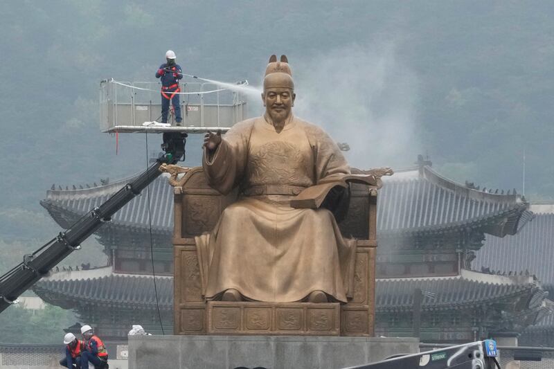 A worker sprays water onto the statue of King Sejong for a spring cleaning in Seoul, South Korea.  He was the fourth king of the Joseon Dynasty (1392-1910) and created the Korean alphabet, Hangul, in 1446. AP
