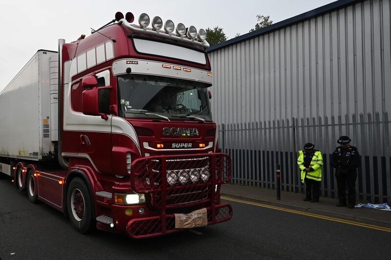 (FILES) In this file photo taken on October 23, 2019 Police officers drive away a lorry in which 39 dead bodies were discovered sparking a murder investigation at Waterglade Industrial Park in Grays, east of London, on October 23, 2019. A British lorry driver on April 8, 2020 pleaded guilty to the manslaughter of 39 people found dead in a refrigerated truck in southeast England. Northern Ireland man Maurice Robinson, 25, was arrested shortly after the bodies of 31 men and eight women were discovered in the truck in an industrial zone in Grays, east of London, in October.
 / AFP / Ben STANSALL
