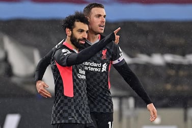 Liverpool's Egyptian midfielder Mohamed Salah (L) celebrates with Liverpool's English midfielder Jordan Henderson (R) after scoring their second goal during the English Premier League football match between West Ham United and Liverpool at The London Stadium, in east London on January 31, 2021. RESTRICTED TO EDITORIAL USE. No use with unauthorized audio, video, data, fixture lists, club/league logos or 'live' services. Online in-match use limited to 120 images. An additional 40 images may be used in extra time. No video emulation. Social media in-match use limited to 120 images. An additional 40 images may be used in extra time. No use in betting publications, games or single club/league/player publications. / AFP / POOL / Justin Setterfield / RESTRICTED TO EDITORIAL USE. No use with unauthorized audio, video, data, fixture lists, club/league logos or 'live' services. Online in-match use limited to 120 images. An additional 40 images may be used in extra time. No video emulation. Social media in-match use limited to 120 images. An additional 40 images may be used in extra time. No use in betting publications, games or single club/league/player publications.