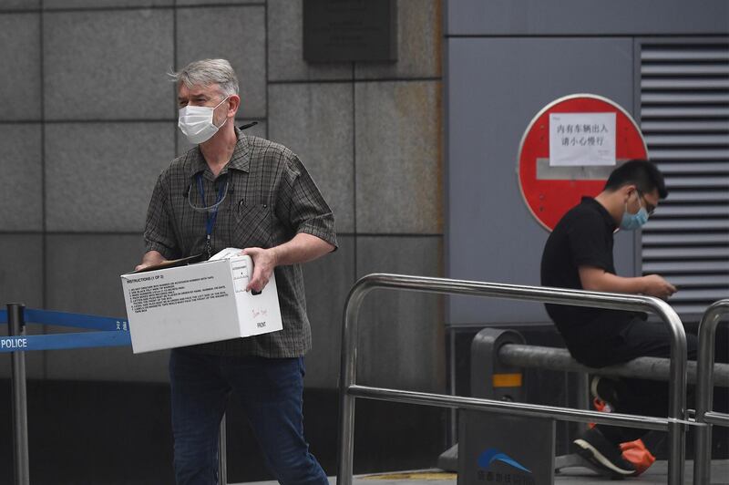 A man carries a box out of the US consulate in Chengdu. AFP
