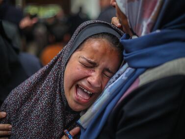 People mourn as they receive the dead bodies of victims of an Israeli strike on March 19, 2024 in Rafah, Gaza. Getty Images