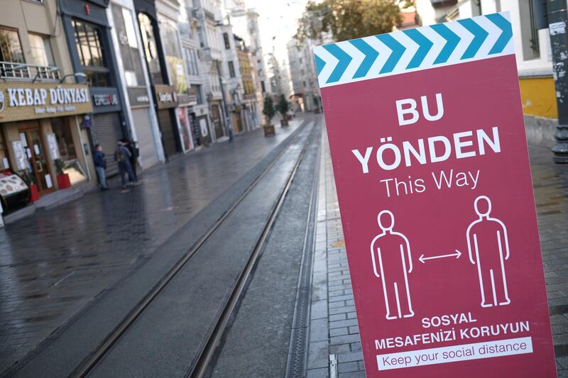FILE PHOTO: A social distancing sign is seen at the entrance of the main shopping and pedestrian street of Istiklal?during a nation-wide weekend curfew which was imposed to prevent the spread of the coronavirus disease (COVID-19), in Istanbul, Turkey December 5, 2020. REUTERS/Murad Sezer/File Photo