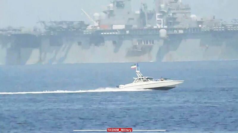 An IRGC speedboat moves alongside the USS Bataan in the Strait of Hormuz in the Arabian Gulf. AP