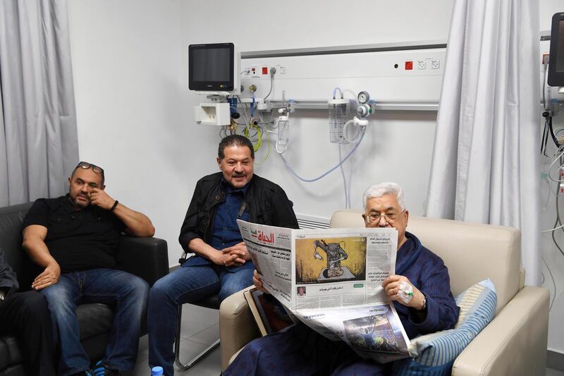 epa06754881 A handout photo made available by the Palestinian President office shows the Palestinian leader Mahmoud Abbas (R) reading the newspaper, with both sons next to him as he recovers at a hospital in Ramallah, West bank,  21 May 2018. Media report that the Palestinian President Mahmoud Abbas hospitalization for the third time in the past week has led to conflicting reports about his health.  EPA/Thaer Ghanaim HANDOUT  HANDOUT EDITORIAL USE ONLY/NO SALES
