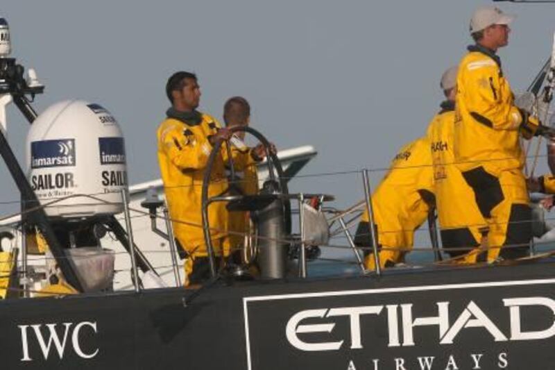 Abu Dhabi, United Arab Emirates, Jan 4 2012, Volvo Ocean Race , Abu Dhabi-(right ) Adil Khalid at the helm at the finish line as they complete leg two, Cape Town South Africa to Abu Dhabi United Arab Emirates of the .   Mike Young / The Nationa