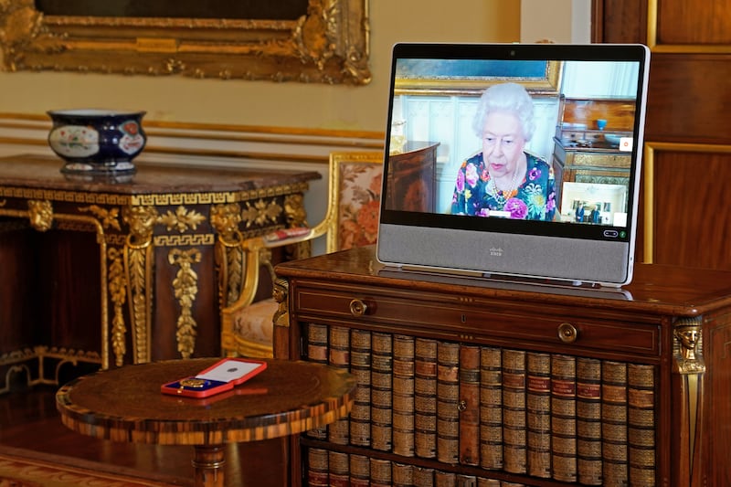 The British monarch on a screen via video link from Windsor Castle during a virtual audience at Buckingham Palace in October.