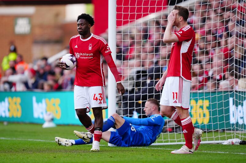 Nottingham Forest's Ola Aina, left, goalkeeper Matz Sels and Chris Wood react after Josko Gvardiol scored for Manchester City. PA