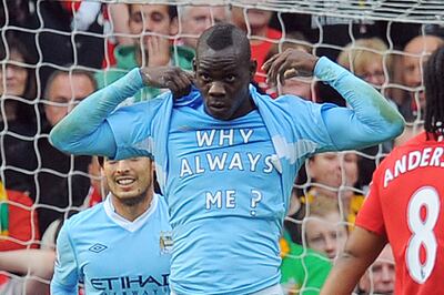 Mario Balotelli shows off his infamous 'Why Always Me?’ t-shirt after scoring for Manchester City against Manchester United at Old Trafford in 2011. AFP