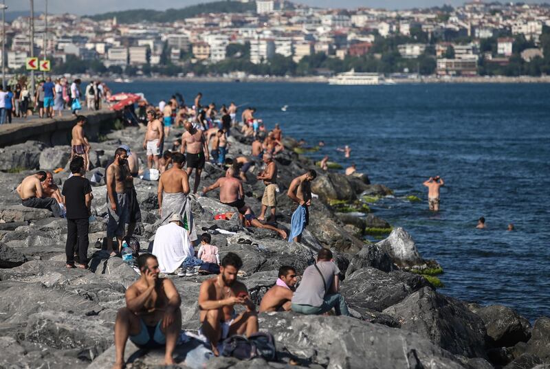 People spend time near the Bosphorus on a sunny day in Istanbul, Turkey. Turkish authorities have now allowed the reopening of restaurants, cafes, parks and beaches, besides lifting the ban on inter-city travel. EPA