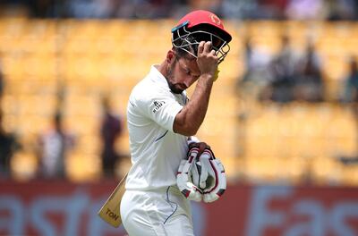 Afghanistan's Javed Ahmadi leaves the ground after losing his wicket during the second day of one-off cricket test match against India in Bangalore, India, Friday, June 15, 2018. (AP Photo/Aijaz Rahi)