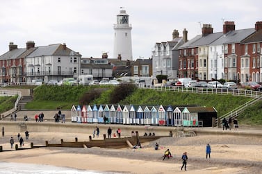 People enjoy the beach along the sea front at Southwold, Suffolk, as Easter holiday temperatures will spring to summertime heights this weekend with the hottest day of the year expected to arrive on British shores. (Photo by Chris Radburn/PA Images via Getty Images)