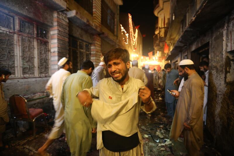 epa06879222 Supporters of political party Awami National Party reacts after a suicide bomb attack that targeted Haroon Bilour a leader of political party Awami National Party during an election campaign in Peshawar, Pakistan, 10 July 2018. At least 10 people were killed including Haroon Bilour in the incident, while more than 15 were injured. Pakistan is set to hold general and provincial elections on 25 July with around 105 million people registered to vote, according to the electoral commission.  EPA/ARSHAD ARBAB