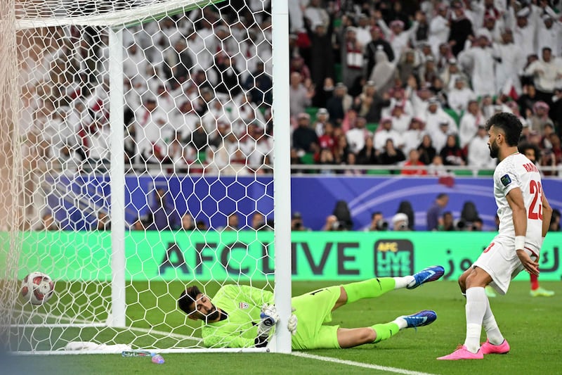 Iran goalkeeper Alireza Beiranvand fails to stop Qatar's Jassem Gaber scoring to make it 1-1. AFP