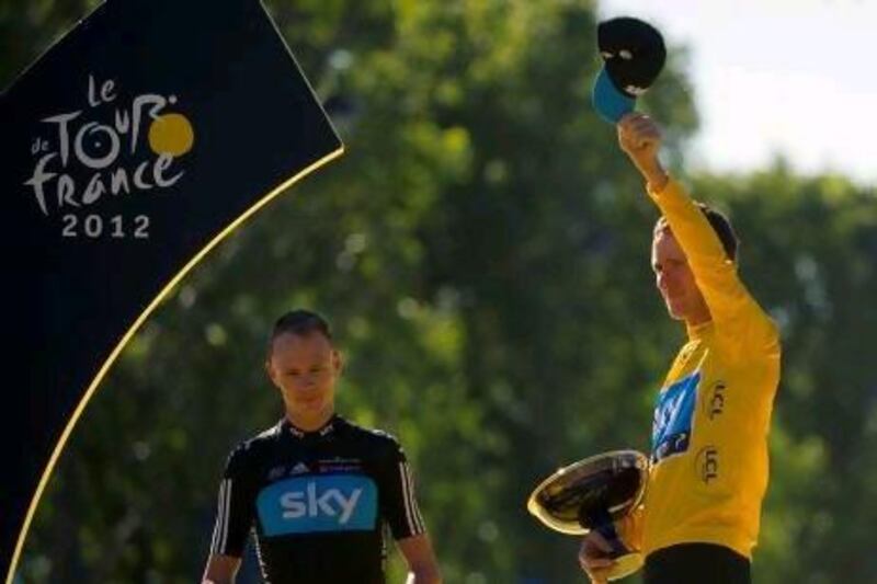 Team Sky's Bradley Wiggins, right, celebrates on the podium at the end of the 120km and last stage of the 2012 Tour de France after becoming the first Briton to win the famous race. Lionel Bonaventure / AFP