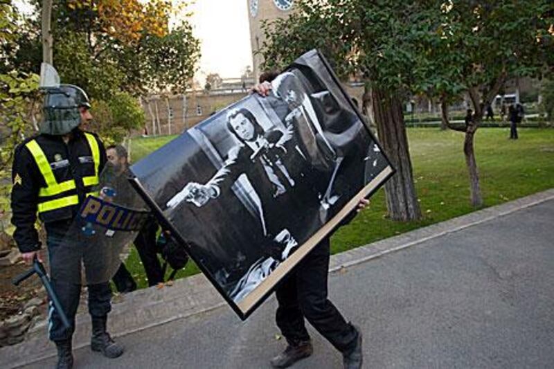 A protester walks with a poster of the film Pulp Fiction after storming the British embassy in Tehran.