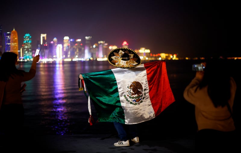 A Mexico fan flies the flag at the Corniche in Doha. Reuters