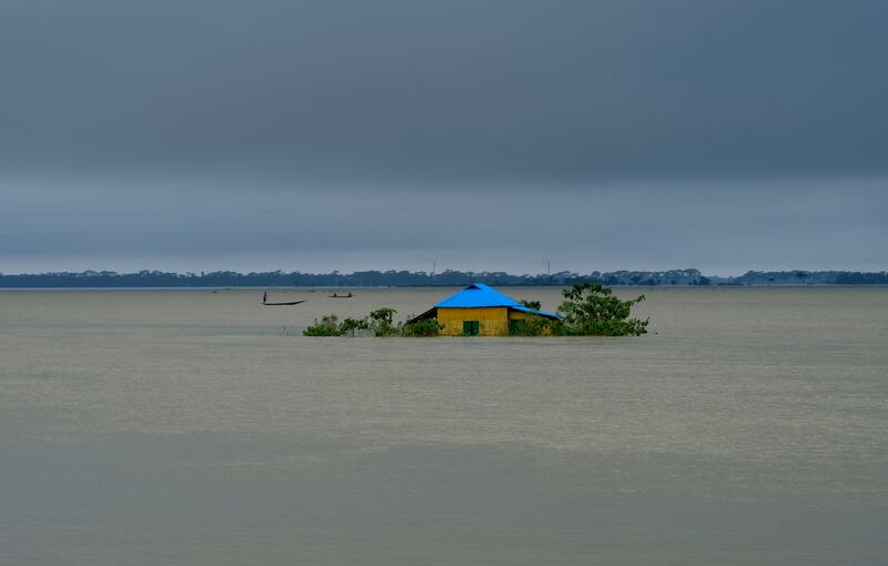 A house stands surrounded by floodwaters in Sylhet, eastern Bangladesh. Monsoon rains have brought heavy flooding to north-eastern India and Bangladesh, killing dozens of people. AP Photo