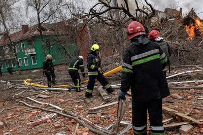 Firefighters at a burning building after a missile attack near the Kharkiv International Airport. Reuters