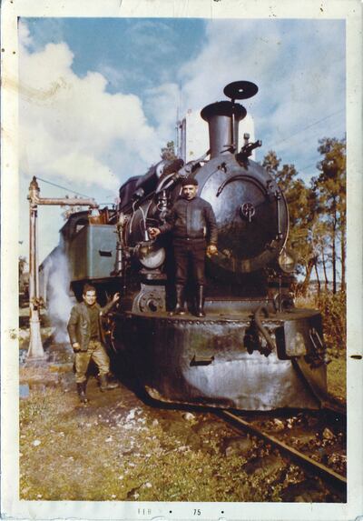 An undated photo of Namroud (left) posing next to his train in Riyaq. This photo is shown in Beirut's airport. Courtesy of Eddy Choueiry.