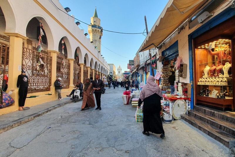 Libyans walk through a shopping street in the old quarter of the capital Tripoli, on January 20, 2020. - A peaceful solution to Libya's protracted conflict remains uncertain despite an international agreement struck in Germany, analysts say, as a fragile ceasefire between warring factions brought only a temporary truce. (Photo by Mahmud TURKIA / AFP)