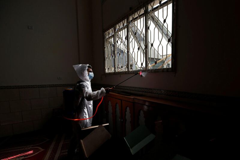 A Palestinian worker sanitizes a mosque amid the coronavirus disease (Covid-19) outbreak in Gaza City. Reuters
