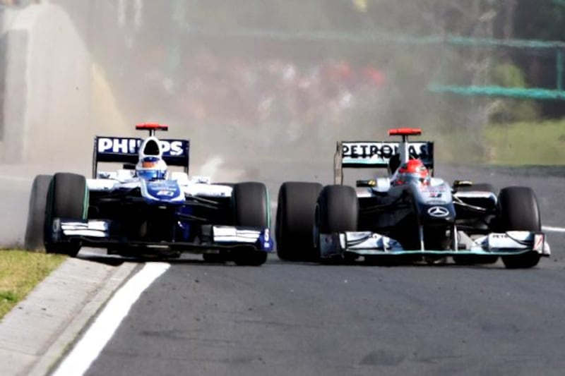 Michael Schumacher (GER) Mercedes GP MGP W01 squeezes Rubens Barrichello (BRA) Williams FW32 into the pit wall and onto the grass.

Formula One World Championship, Rd 12, Hungarian Grand Prix, Race, Budapest, Hungary, Sunday 1 August 2010.


