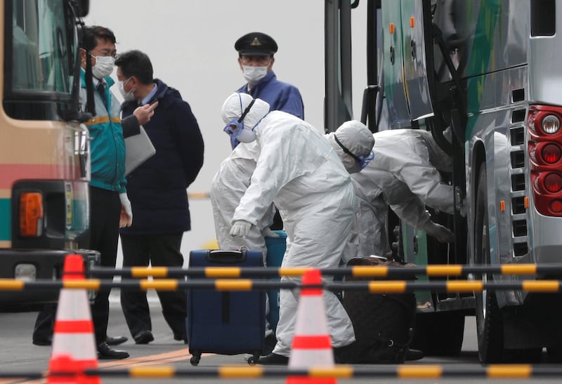 Workers load luggage into a bus as a second group of passengers from the coronavirus-hit Diamond Princess cruise ship disembark in Yokohama Port, south of Tokyo, Japan, February 20, 2020. REUTERS/Kim Kyung-Hoon