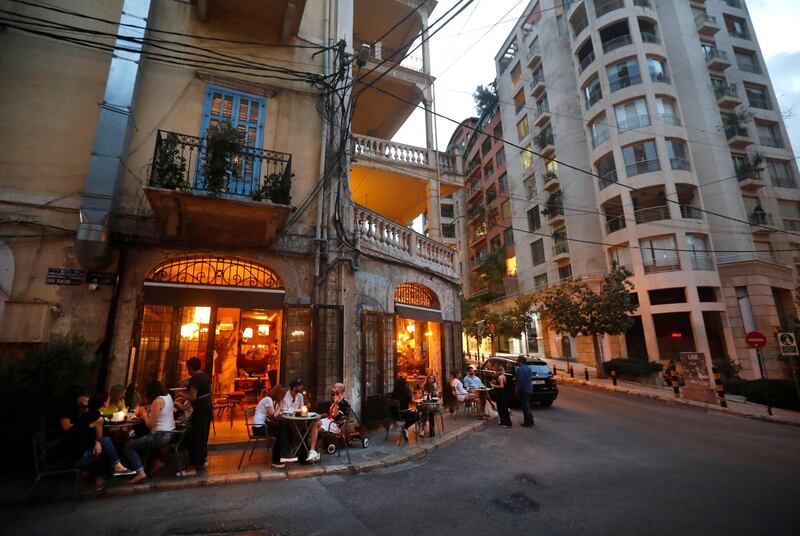 Customers enjoy drinks outside a restaurant on a strategic intersection leading into one of Beirut's neighbourhoods. AP Photo