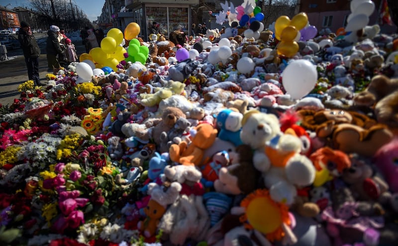 People visit a makeshift memorial in tribute to the victims of a shopping mall fire in the industrial city of Kemerovo in western Siberia. Dmitry Serebryakov / AFP