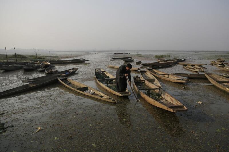 A Kashmiri boatman rows his boat on Wular Lake, north-east of Srinagar in Indian-controlled Kashmir. The lake now holds less half its former capacity, and restoring it may prove too tough. Mukhtar Khan / AP Photo / October 29, 2016